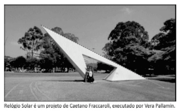 Fotografia do relógio solar da USP com linha inclinada e legenda: Relógio Solar é um projeto de Caetano Fraccaroli, executado por Vera Pallamin.